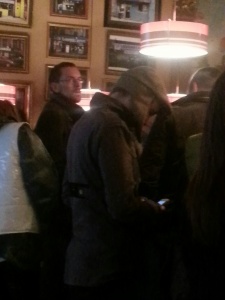 Jónsi in a hat looking at his phone - my paparazzi skills are lacking.